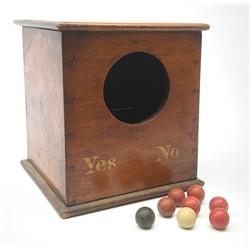 A Victorian mahogany ballot box, detailed Yes and No, H25cm, with six red, one black, and one white clay balls, probably of the same period. 