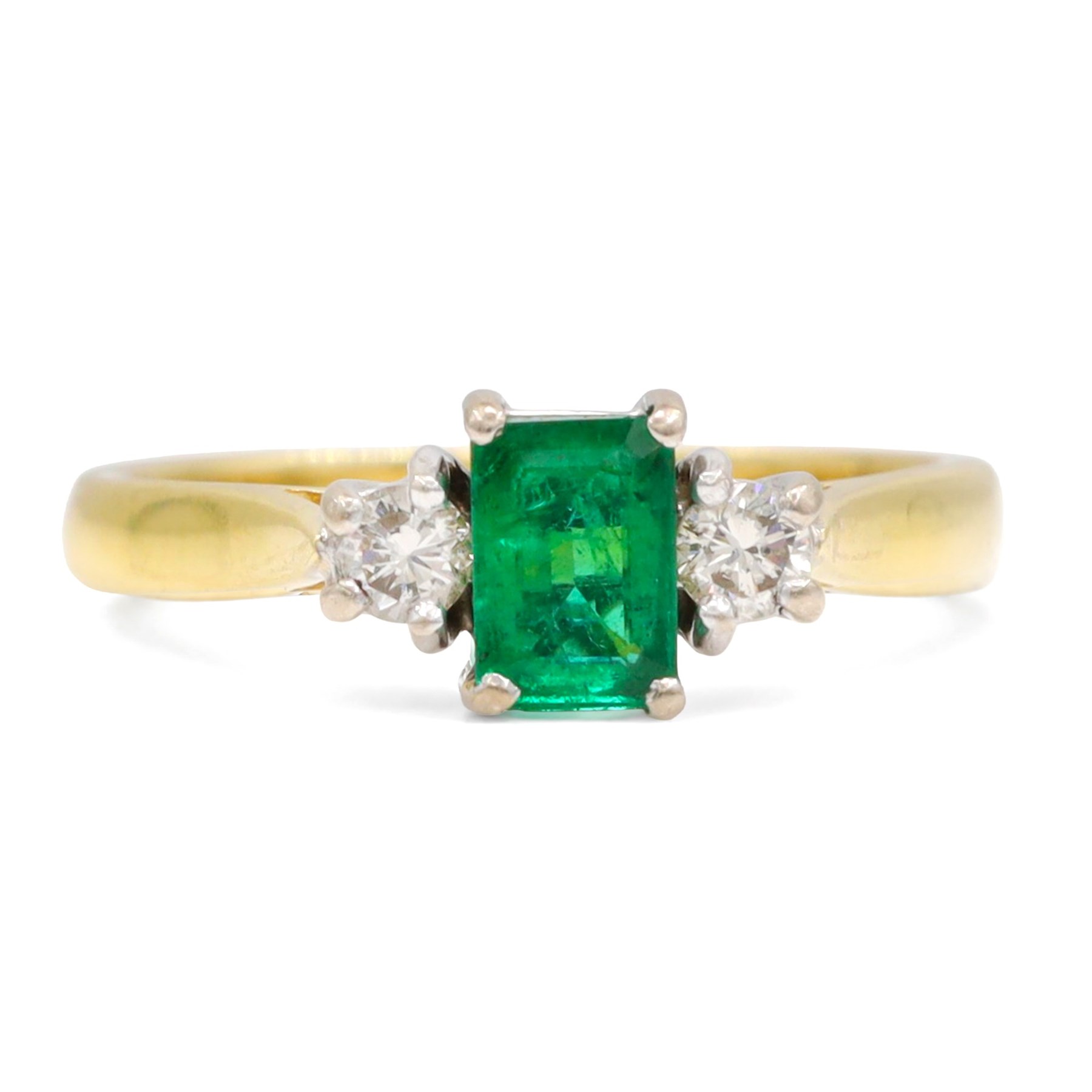 18ct gold emerald and diamond three stone ring, single octagonal cut emerald of approx 0.40 carat, with a round brilliant cut diamond set either side, Birmingham 1997, total diamond weight approx 0.15 carat