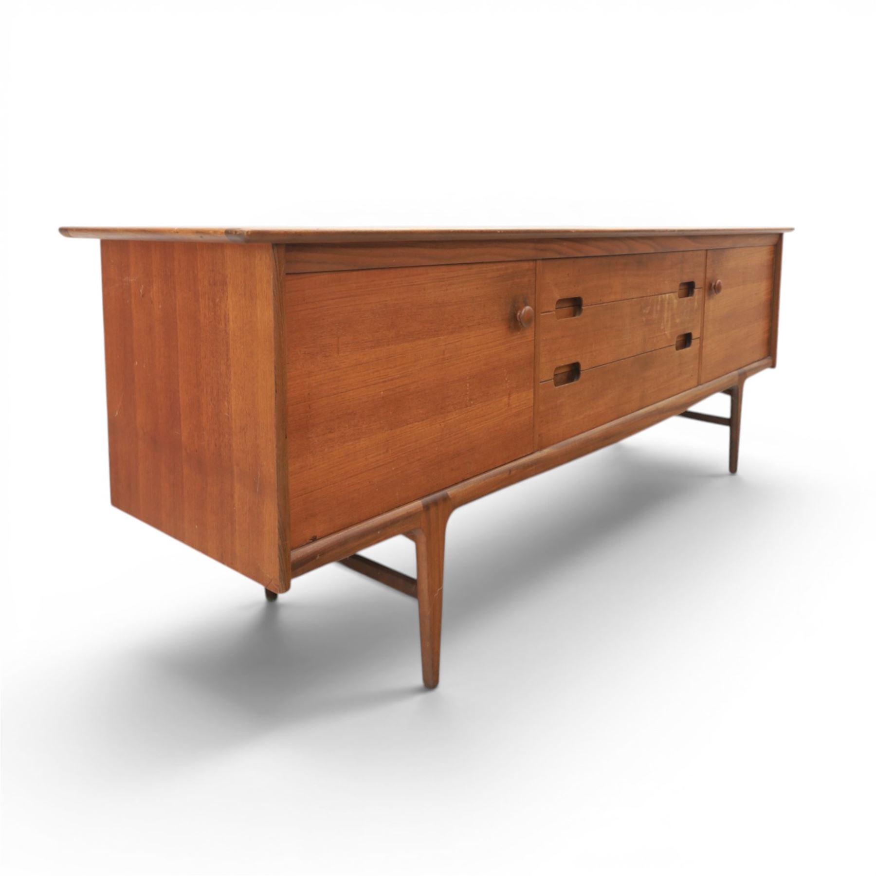 John Herbert for Youngers - 'Fonseca' mid-century teak sideboard, rectangular top above a central bank of three drawers one fitted for cutlery, flanked by cupboards with fixed shelved interior, raised on tapering supports 