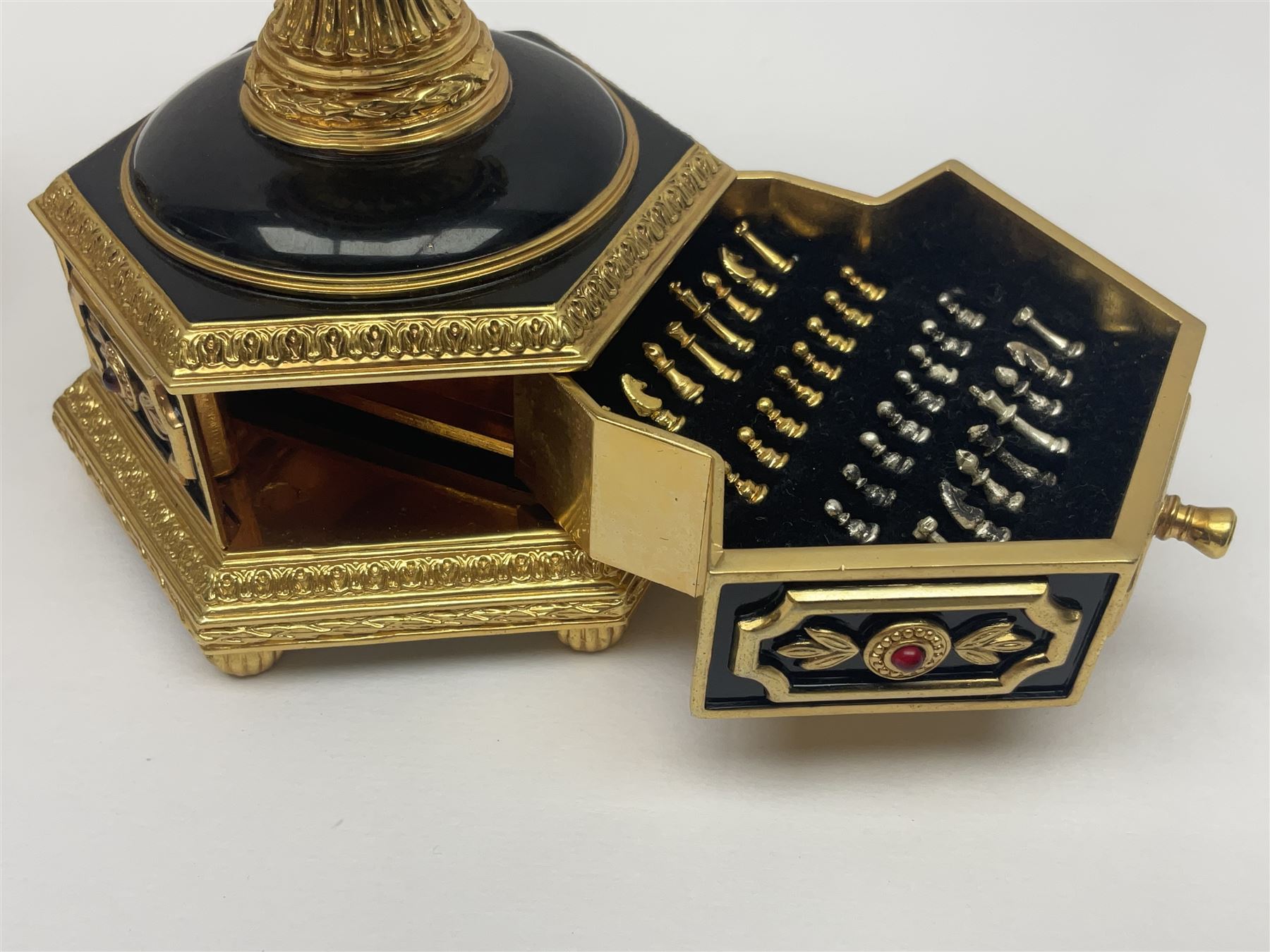 Franklin Mint House of Faberge; The Imperial Jeweled Egg Chess set, the egg opening to reveal a chess board, with a draw to the hexagonal base holding the miniature chess pieces, H23cm 