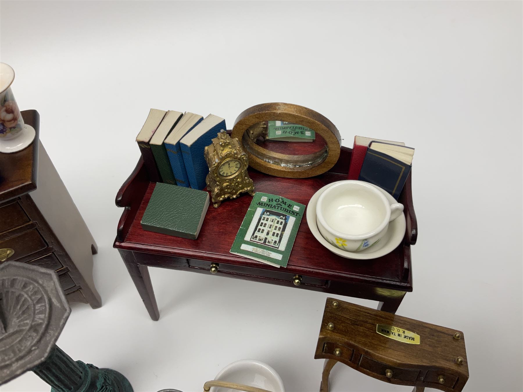 Collection of miniature dolls house furniture and accessories, to include long case clock, chest of drawers, tiled wash stand, ceramics and glass ware, mirror, baskets, etc 