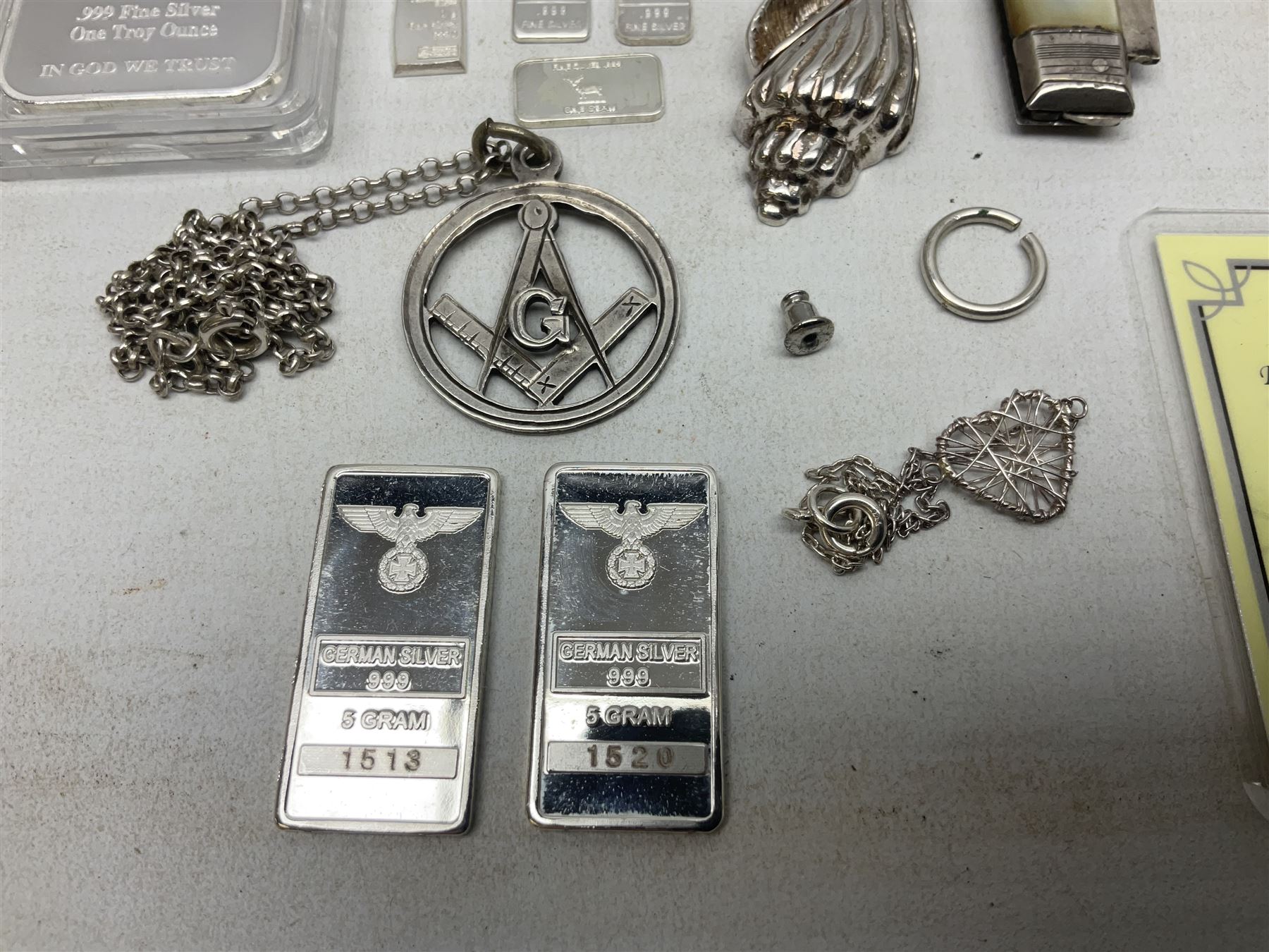 Silver mother of pearl handled fruit knife, silver jewellery including masonic pendant necklace, shell pendant, coin ring, Claddagh ring and charms etc, and a collection of ingots