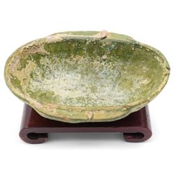 Two small Chinese terracotta 'ear' shaped wine cups, probably Western Han Dynasty c.206BC-24AD, one with green glaze, each on hardwood stand, W12cm (2)