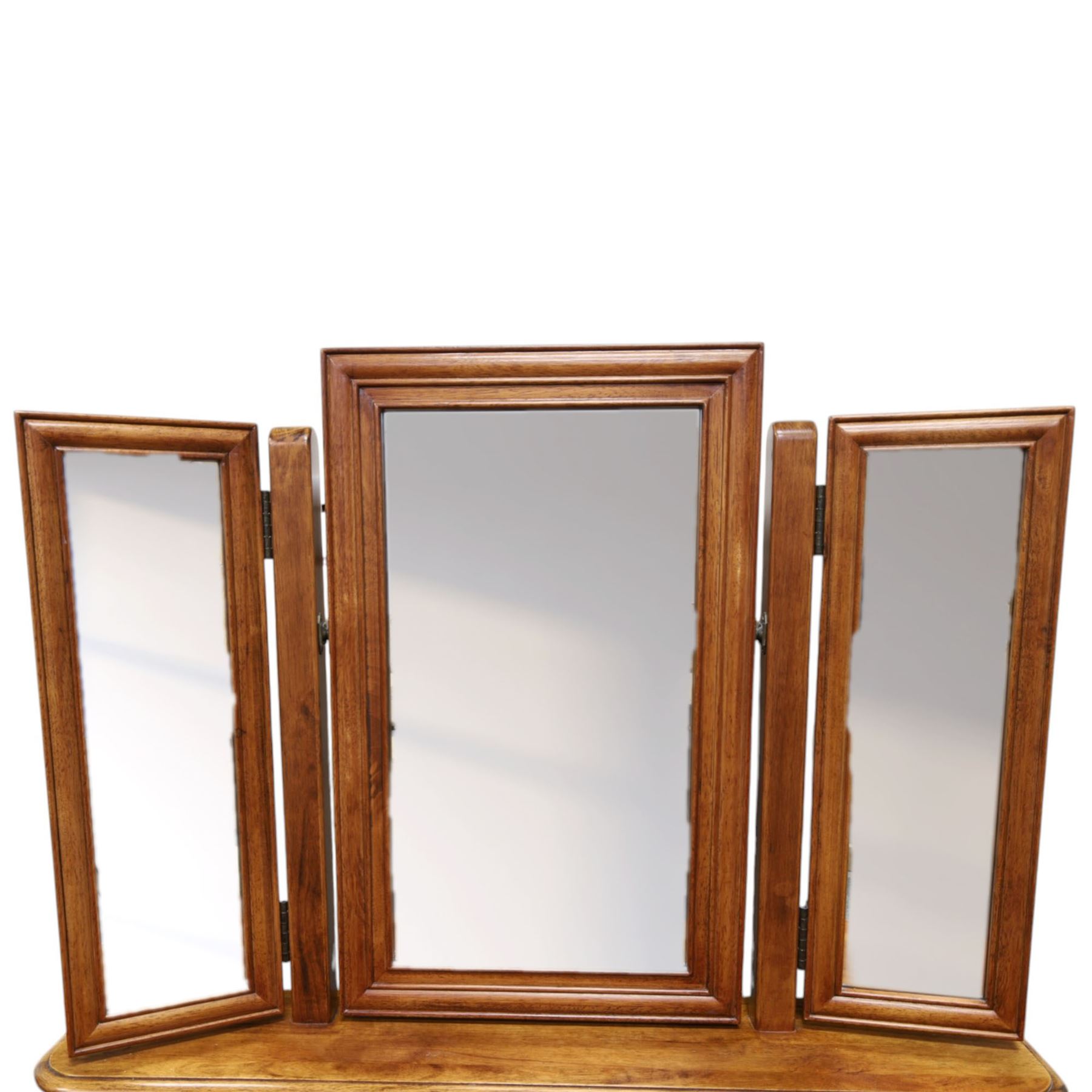 Willis & Gambier - mahogany dressing table, three part mirror and stool, the dressing table with rectangular top with chamfered corners, over two baize lined frieze drawers, kneehole recess and a single drawer either side, three part mirror with central tilting mirror on a moulded plinth base, with oval beige padded stool 