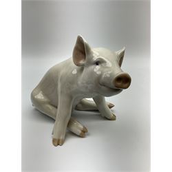 A Royal Copenhagen figure modelled as a seated pig 414, H16cm