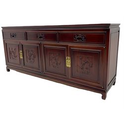 Hardwood sideboard, three drawers over cupboards, the doors relief carved with flowers are birds 