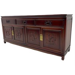 Chinese hardwood sideboard, three drawers above four cupboards, the doors relief carved with flowers and birds 