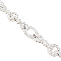 Art Deco platinum diamond bracelet, circa 1920, articulated openwork circular and geometric links, milgrain set with old cut diamonds and baguette cut diamonds, total diamond weight approx 3.85 carat