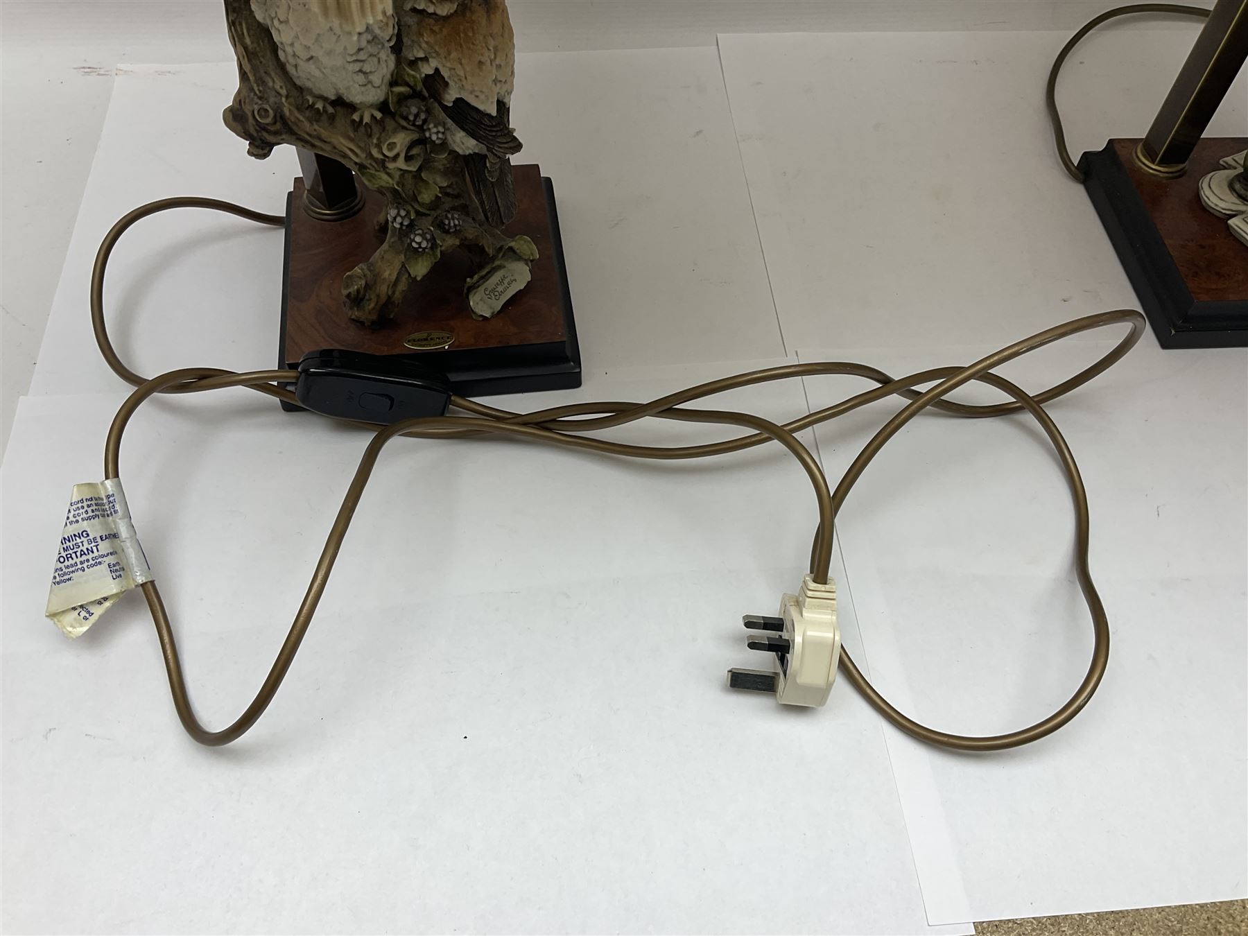 Two Giuseppe Armani figural lamps, the first modelled as an owl perched upon a book, the second modelled as a pair of owls perched upon blackberry branch, each with damask fabric tassel shades, tallest H76cm