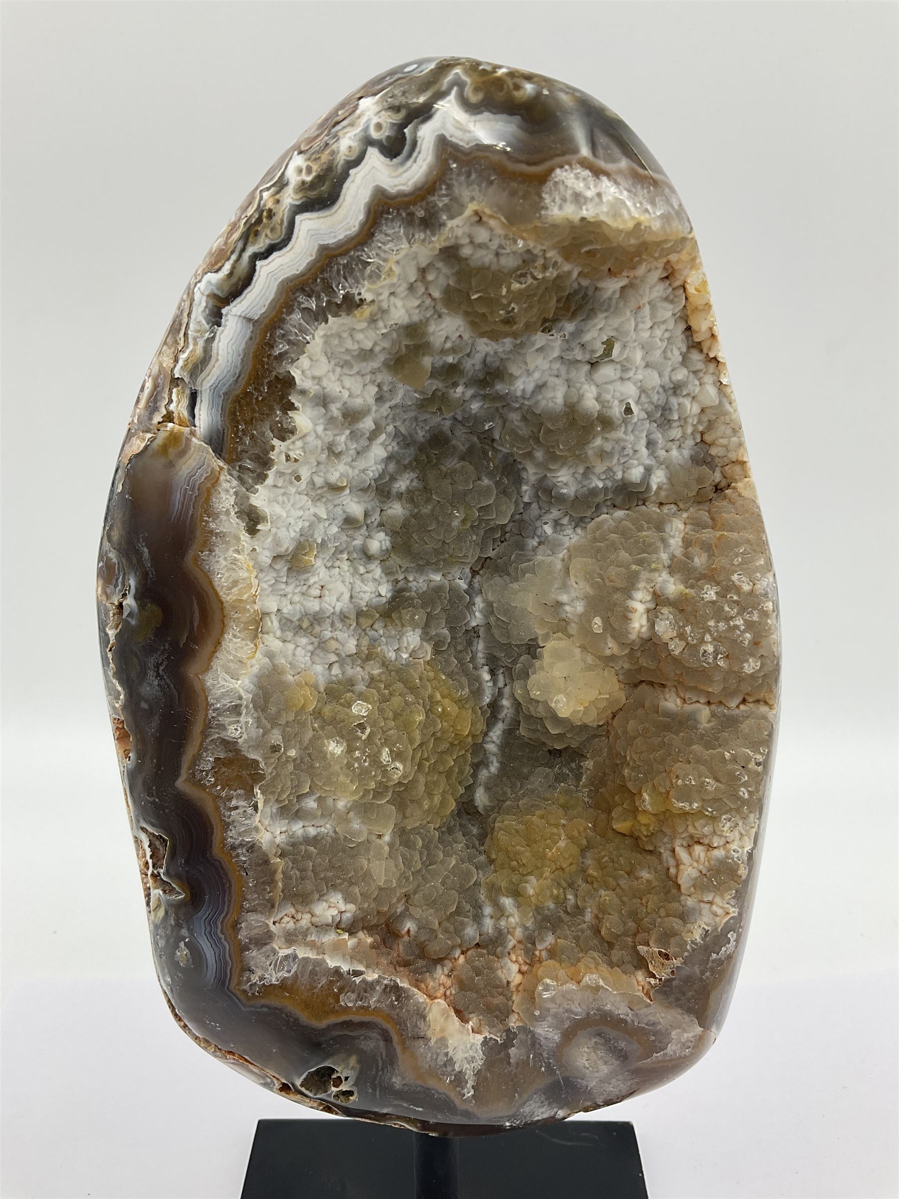 Agate crystal geode cluster, in brown and purple tones, upon a metal stand, H26cm