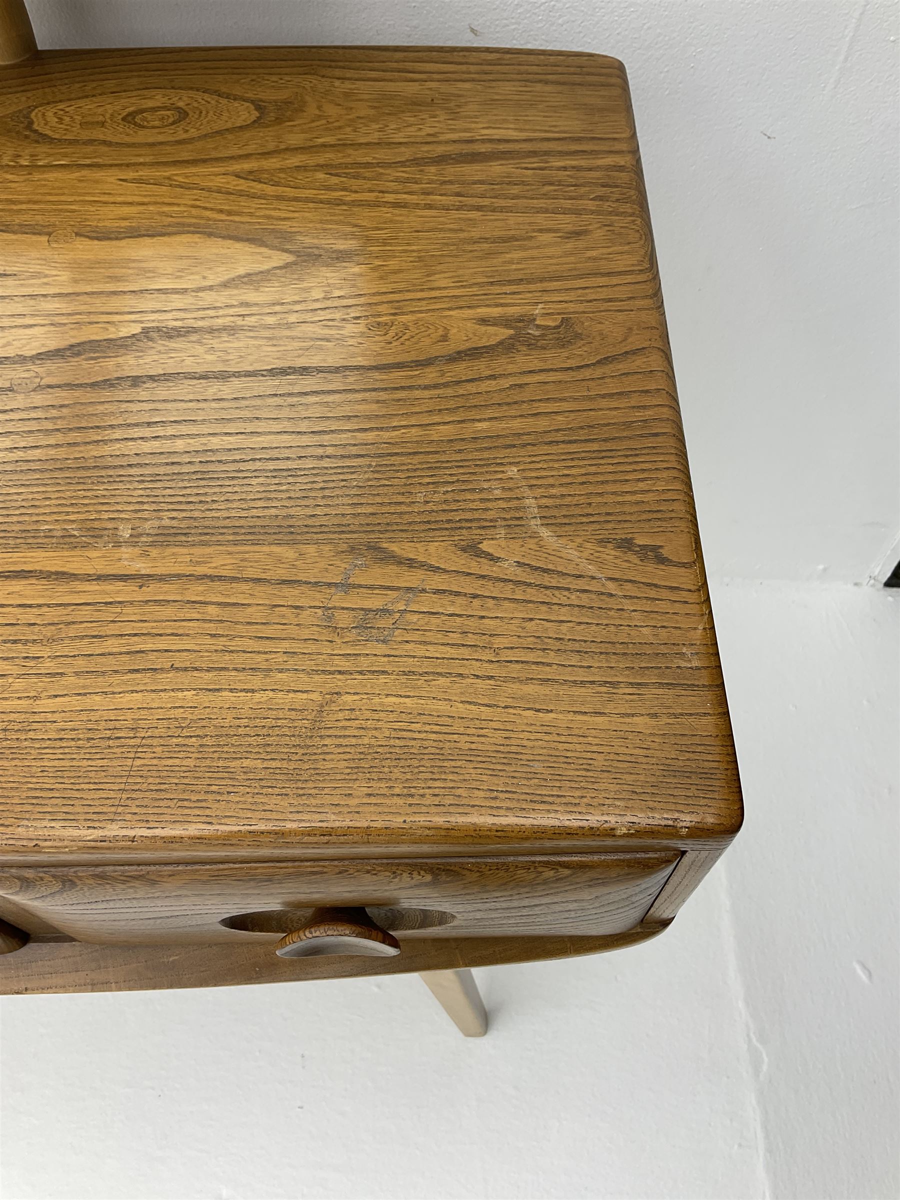 Ercol dressing table with raised back mirror, fitted with one long and two short drawers, raised on tapering supports 
