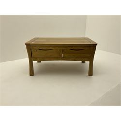 Oak coffee table, fitted with four short drawers, raised on shaped supports 