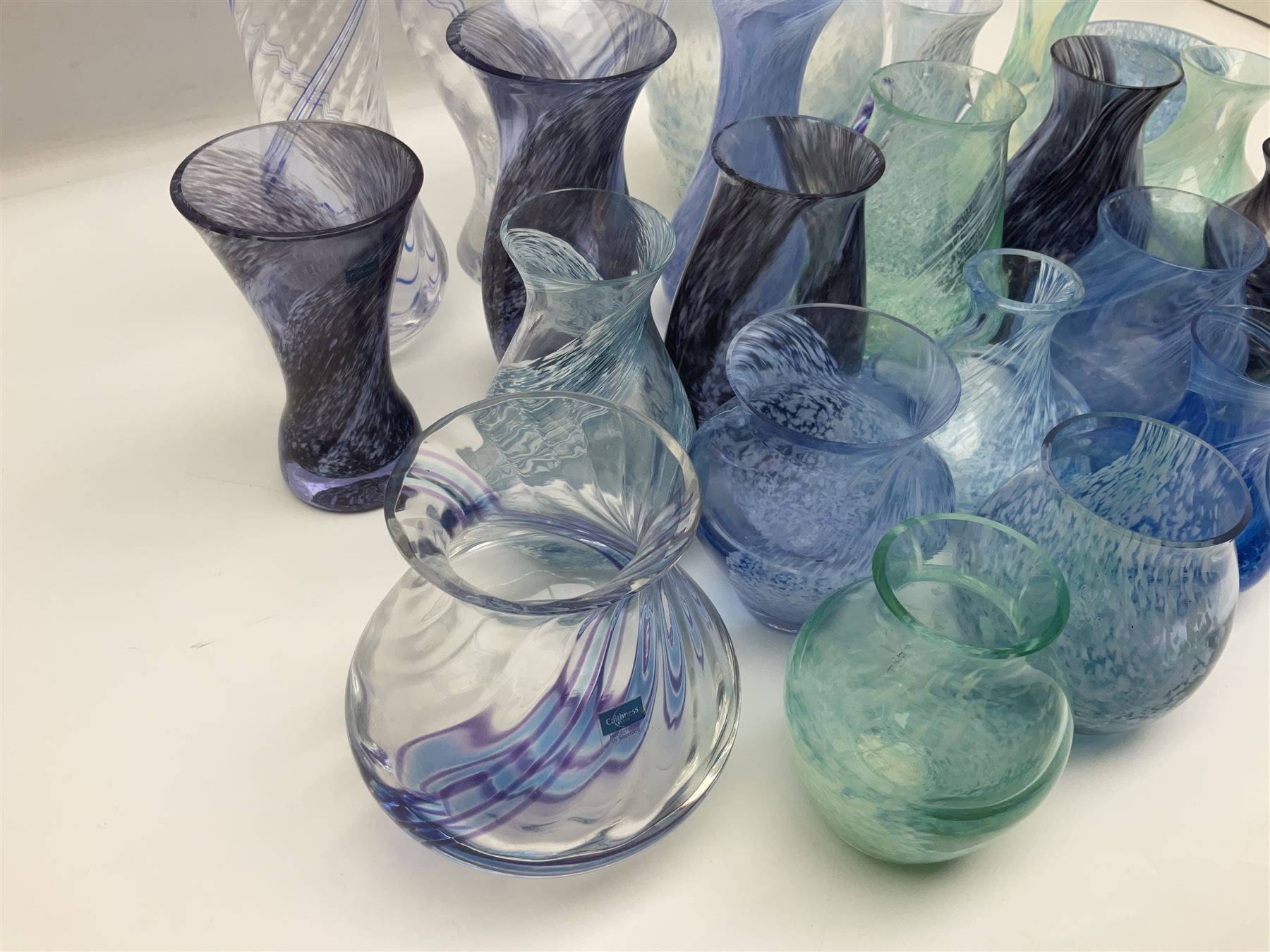 Collection of green/blue Caithness glass vases, to include mottled and swirl designs, largest 20cm (26)