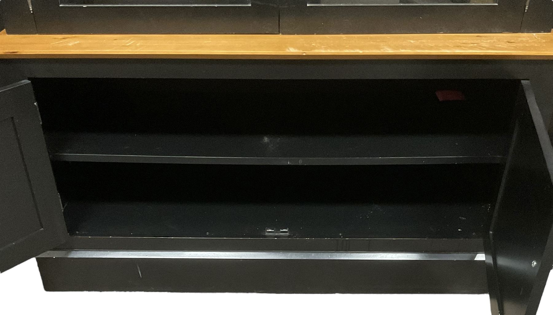 Contemporary polished pine and black finish break-front bookcase, projecting cornice over globular mounts, central cabinet enclosed by two glazed doors over double panelled cupboard, flanked by adjustable shelves, on plinth base