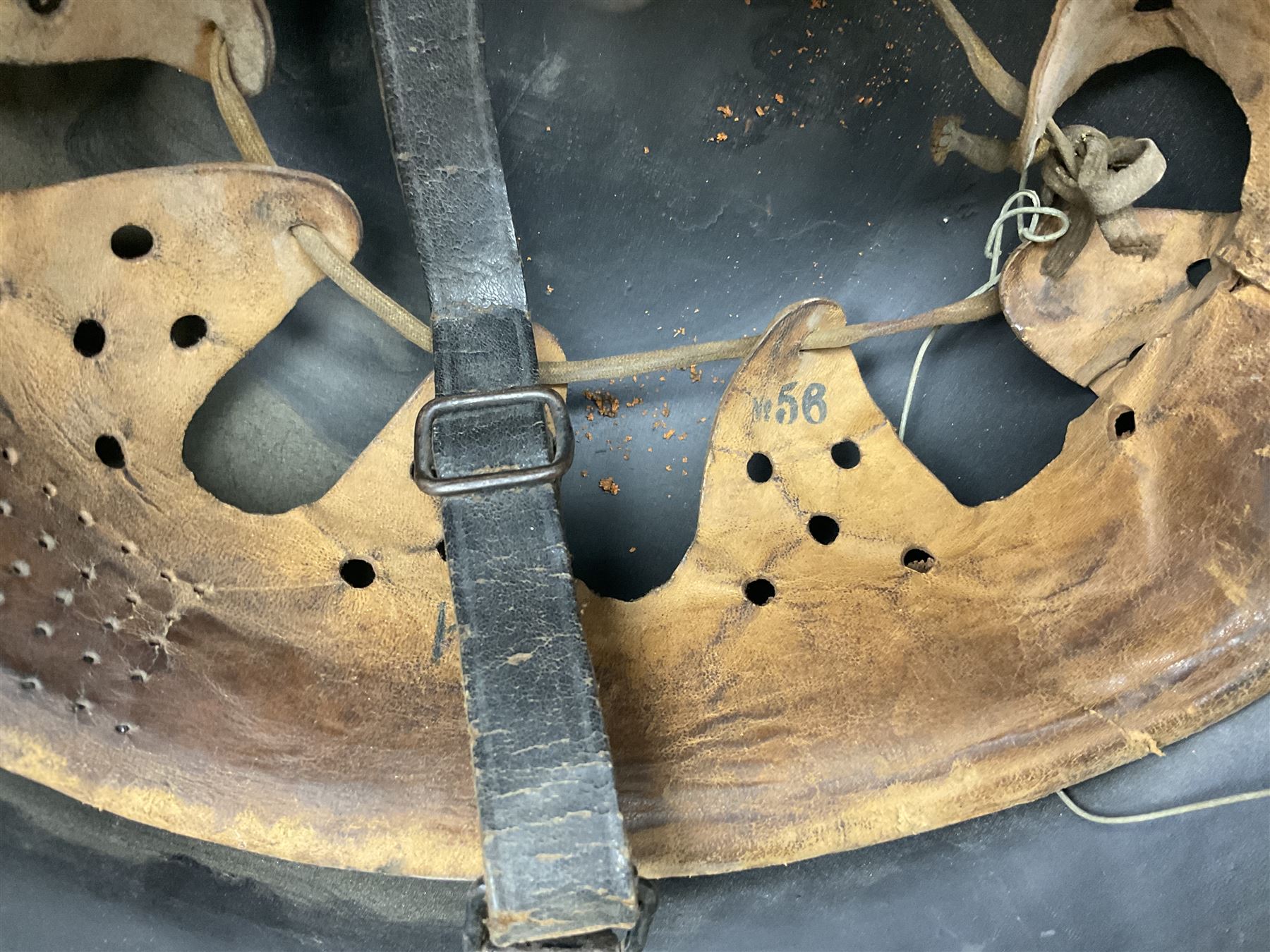 WW2 German steel combat helmet with eagle insignia to one side and U-724 to the other, leather liner marked No.56 and leather chin strap; indistinctly stamped to the skirt '*ahl'