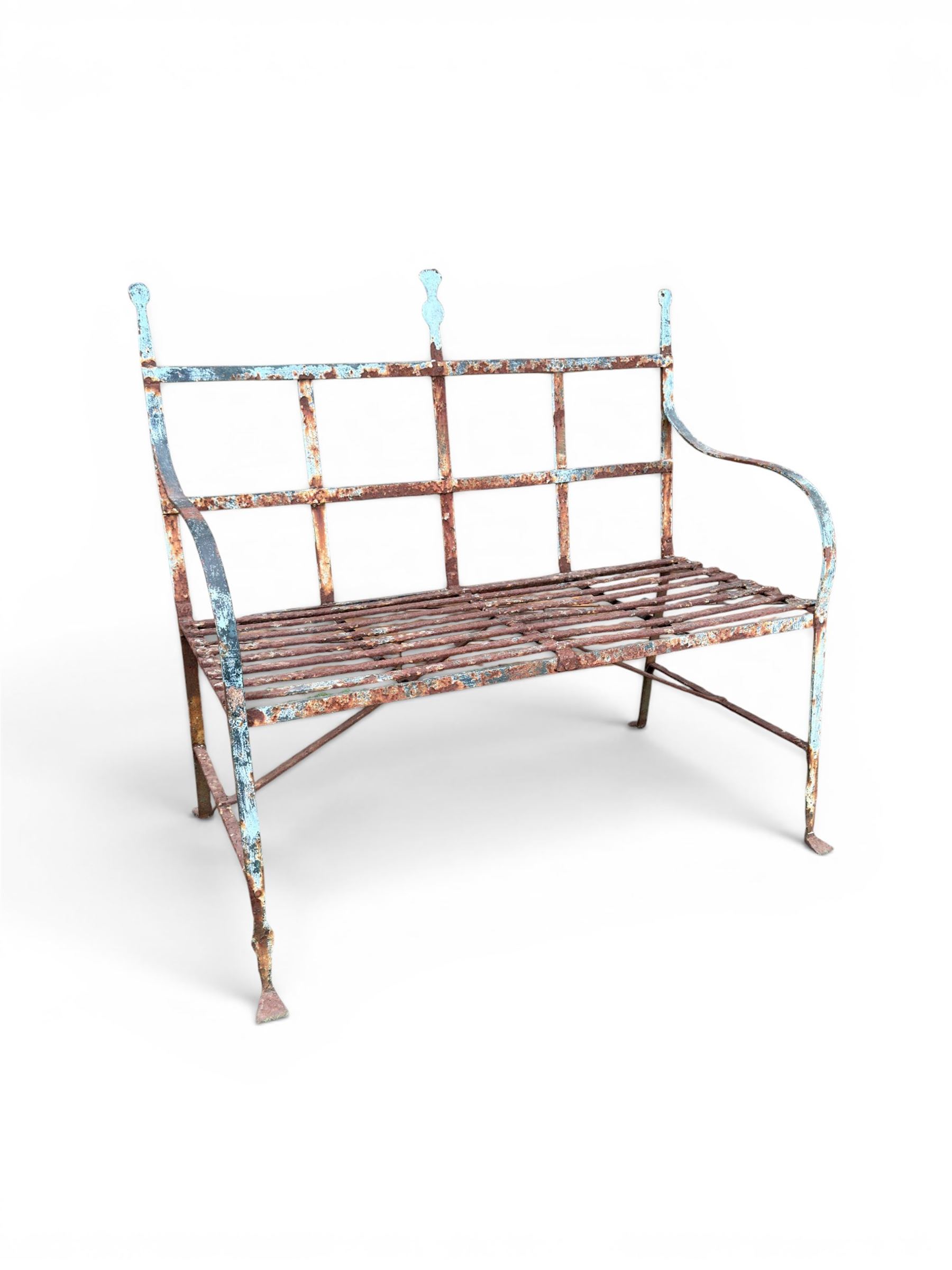 Regency period wrought iron strapwork garden bench, cresting rail with central Scottish thistle motif and flanking pediments, in distressed blue painted finish