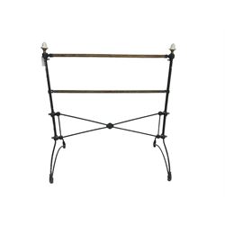Early 20th century wrought metal and brass towel rail, with ceramic finials