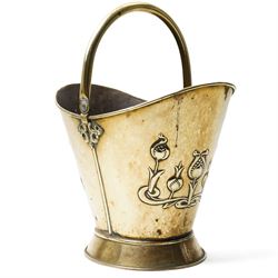 Art Nouveau brass log bucket of oval design with swing handle and a raised pattern of styl...
