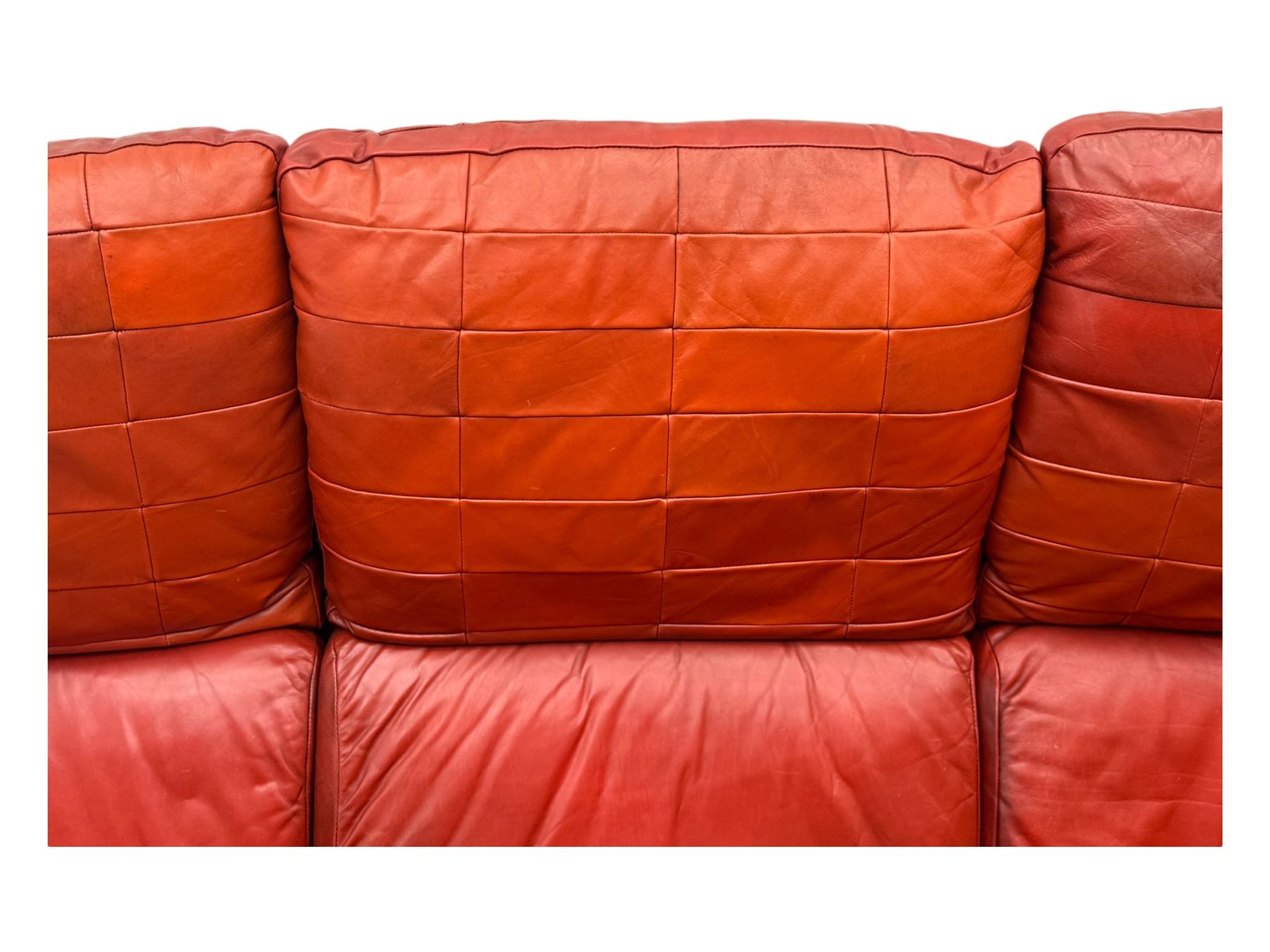 Folke Ohlsson for Gimson & Slater - mid-20th century Danish teak-framed sofa, red leather upholstery with patchwork design, raised on shaped teak side supports