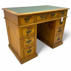 Rustic pine twin pedestal desk, rectangular green leather inset top above a central frieze drawer flanked by two short drawers, each pedestal featuring three graduated drawers, raised on a plinth base