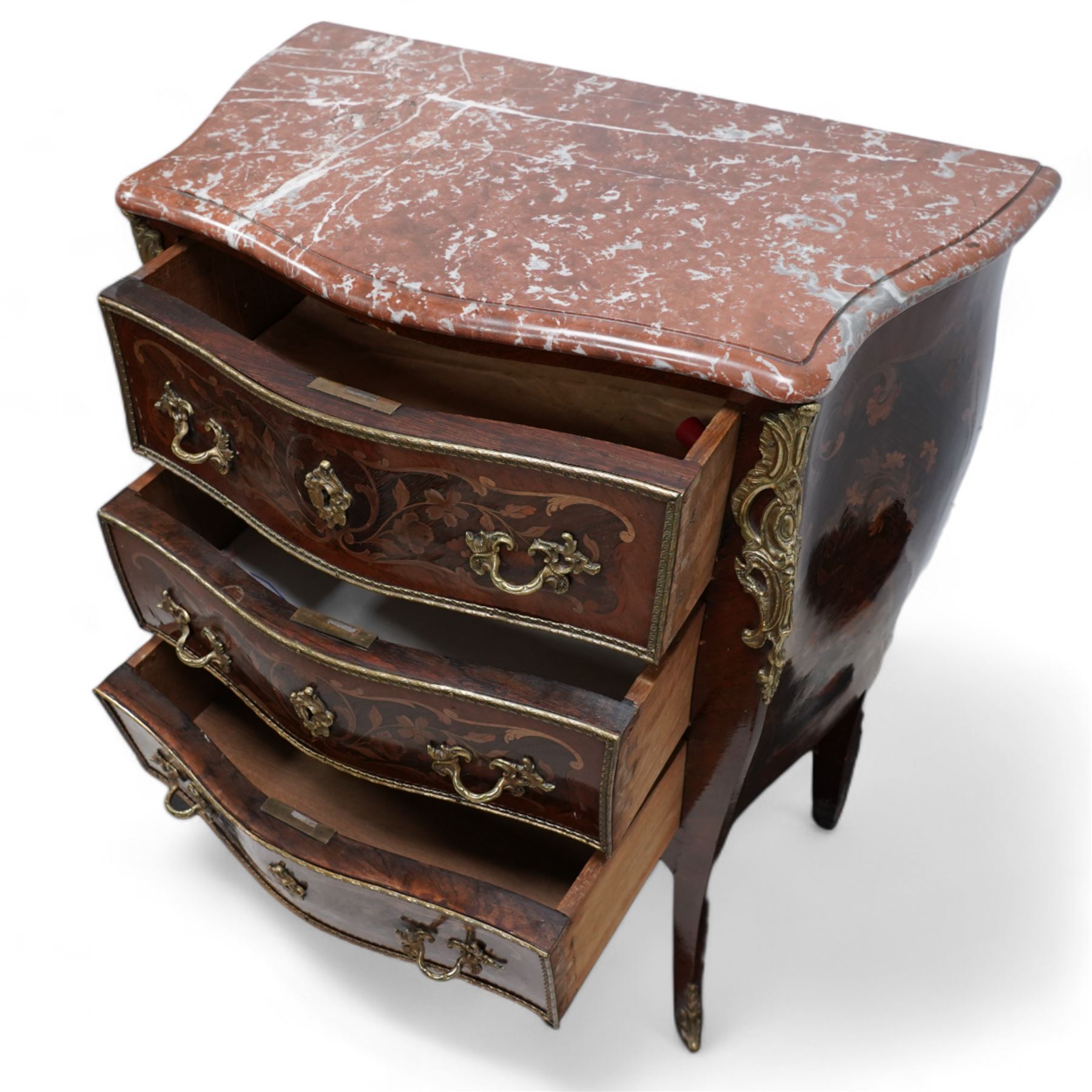 Early 20th century French walnut and rosewood marquetry bombe chest, shaped marble top over three drawers, each with gilt-metal cock-beading and handles, inlaid with overall floral decoration, flanked by gilt metal scrolling cartouche mounts and matching apron, on splayed supports