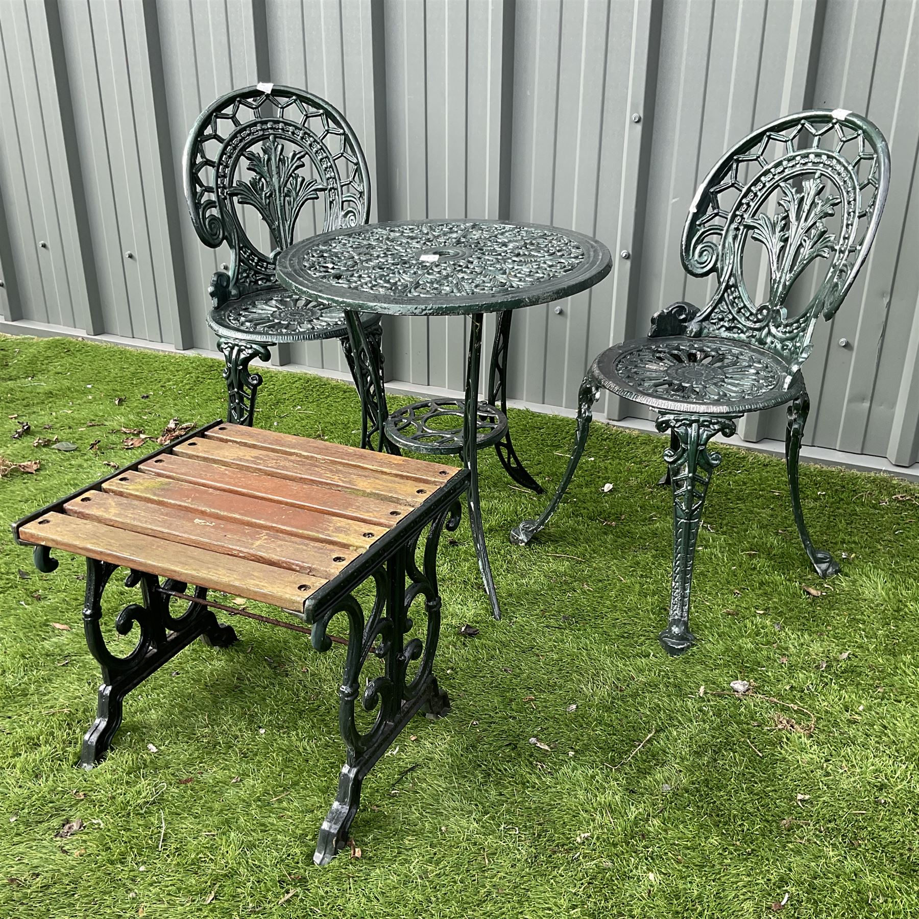 Cast aluminium garden table and two chairs with cast iron side table painted in dark green - THIS LOT IS TO BE COLLECTED BY APPOINTMENT FROM DUGGLEBY STORAGE, GREAT HILL, EASTFIELD, SCARBOROUGH, YO11 3TX