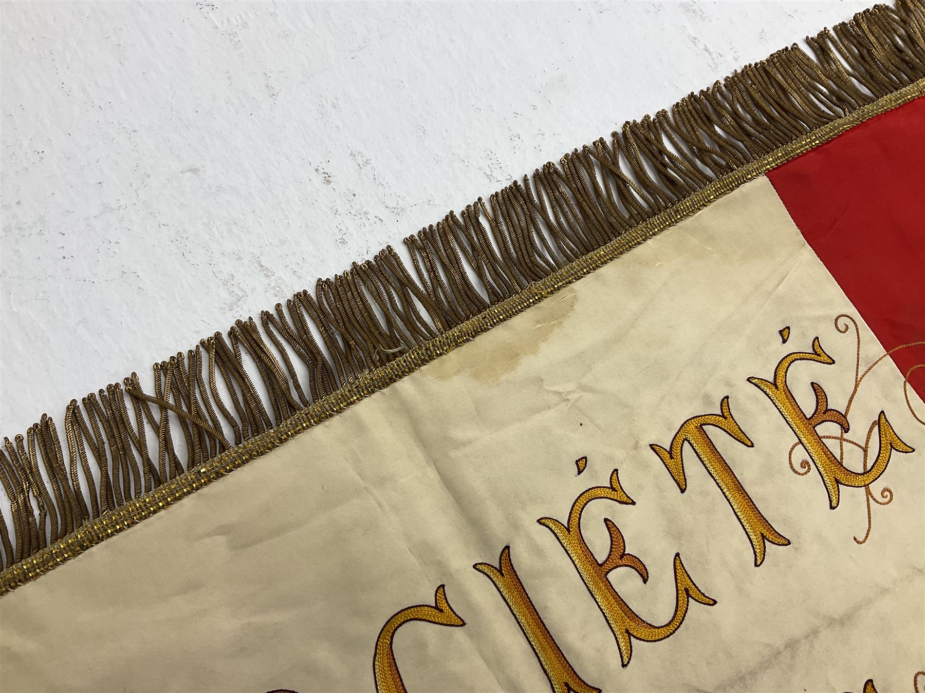 French State Police banner as the tricolor flag embroidered with coloured and metallic thread 'Societe De Secours Mutuels Un Pour Tous Tous Pour Un De La Police D'Eteat De Marseille' to one side; plain flag verso; tassels to three sides 100 x 113cm