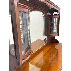 Late Victorian walnut mirror back sideboard or dresser, the raised back fitted with two curved and lead glazed cabinets, central arched bevelled mirror, the sideboard with break bowfront, fitted with six drawers and two cupboards, the cupboard doors panelled and carved with scrolls, shell and plant motifs, shaped apron with cabriole feet
