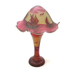 An Art Nouveau style glass table lamp, in the style of Galle, the waisted stem supporting a frilled mushroom shade, decorated throughout with sailboats, overall H44cm. 