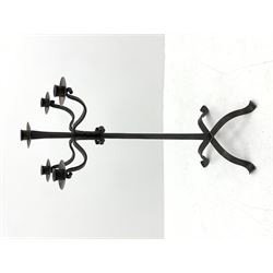 Wrought hand forged iron candle stand, four scrolled branches and central vertical branch with sconces, tapered column on four shaped and out splayed supports