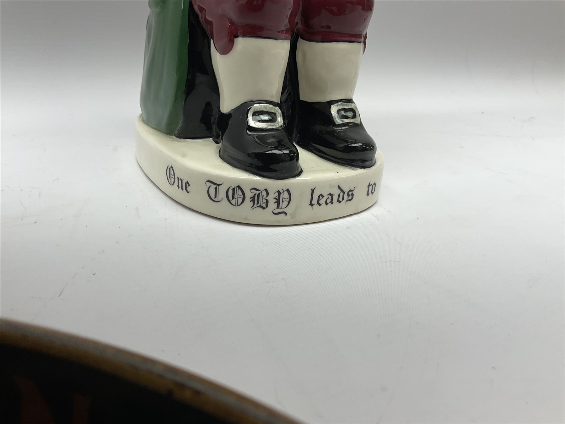 Pair of Royal Doulton Toby Ale Jugs, produced in 1934 for Charrington Ales, together with two circular metal serving trays advertising Charrington brewery, a Charrington badge awarded for 25 years of service and a 1949 menu Fox & Nicholl Ltd annual dinner dance at the toby jug hotel.  