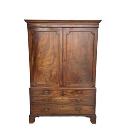 George III mahogany linen press, projecting cornice over two figured doors enclosing five linen slides, the lower section fitted with two short and two long drawers, on bracket feet