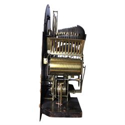 Late nineteenth century ebonised and gilt-bronze mounted musical longcase clock of impressive architectural form, the case of ebonised finish with applied gilt bronze neoclassical inspired masks and mounts, hood of arched form with glazed door, flanked by free fluted columns with gilt bronze Corinthian capitals surmounted by stylized Lion finials, frieze and arch enriched with applied foliate mounts, trunk with a rectangular glazed door bordered by mouldings and flanked by engaged columns with gilt bronze mounts above a shaped projecting base panel with applied central female mask and corner foliate ornamentation, arched brass dial, with a silvered chapter ring and applied cast gilt bronze spandrels and arch decoration, incorporating subsidiary selection dials for chime/silent and tune regulation, offering Cambridge chimes on eight bells and an additional chime sequence on ten bells, brass arch is further embellished with a moon phase aperture with lunar calendar scale, Zodiac symbols, month and date indication on a silvered dial, substantial eight-day, three-train movement with pinned cylinder musical train and a graduated nest of eleven bells with eleven hammers, quarter chiming with separate hour/half-hour strike and chime repetition, movement is regulated by an anchor escapement, with brass disc pendulum, three brass weights, two winding keys and case door key