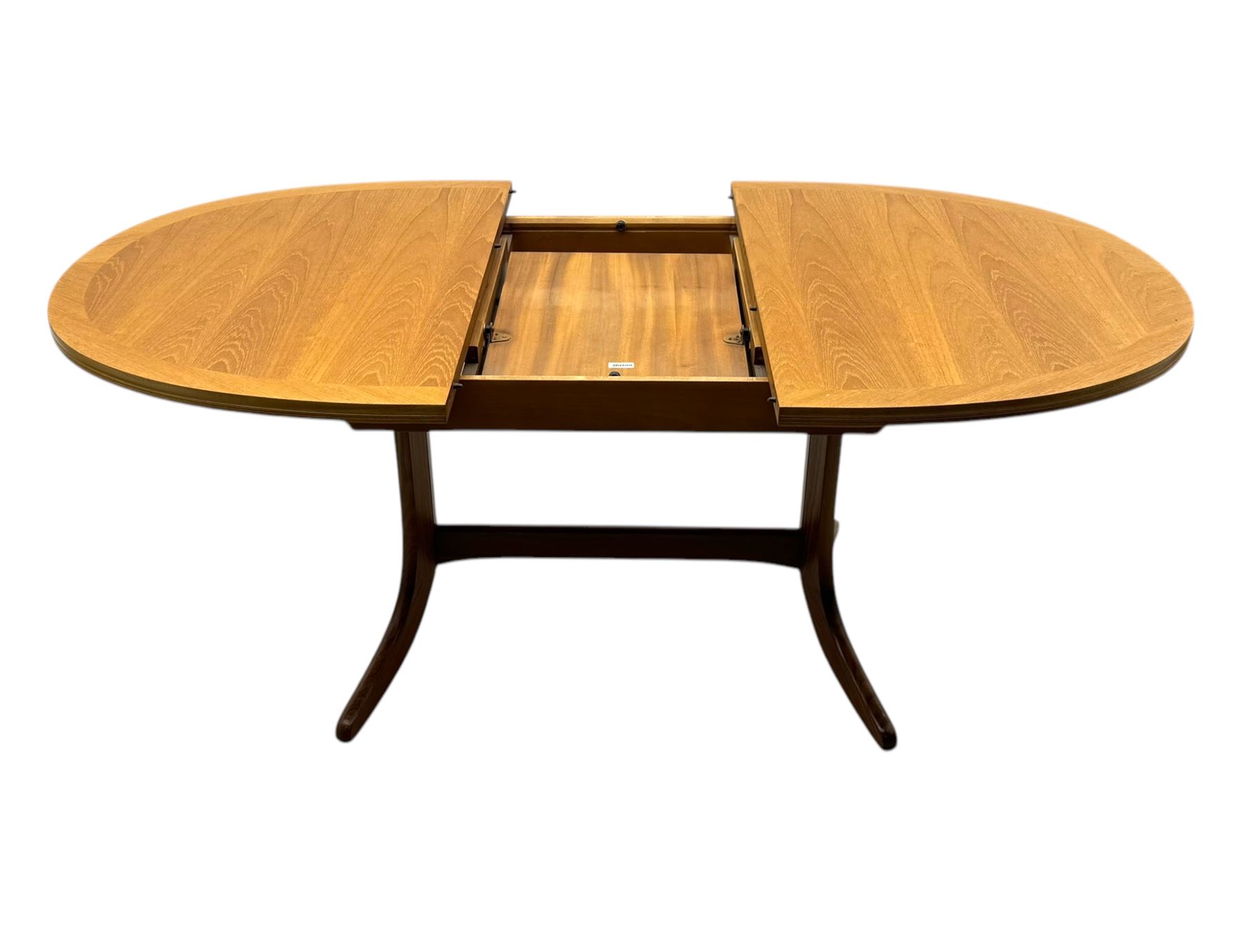 G-Plan - mid-20th century teak extending dining table, oval top with concealed central butterfly leaf extension, raised on splayed supports with cross-stretcher; three dining chairs with curved top rail and vertical splats
