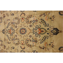  Persian Kashan carpet, pale pistachio green ground with blue  interlacing scrolled design, floral motifs, signed in red, 410cm x 230cm  