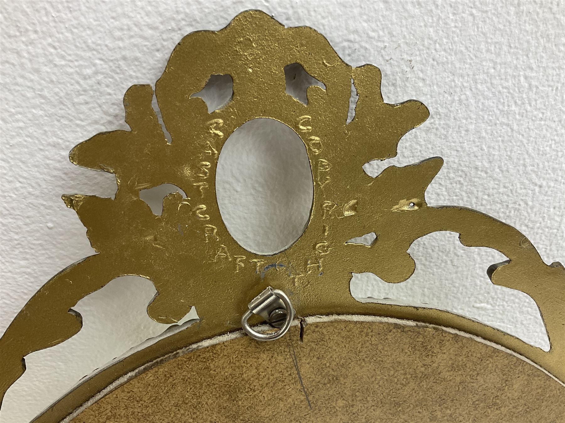 Ornate brass wall mirror with oval plate, L78cm