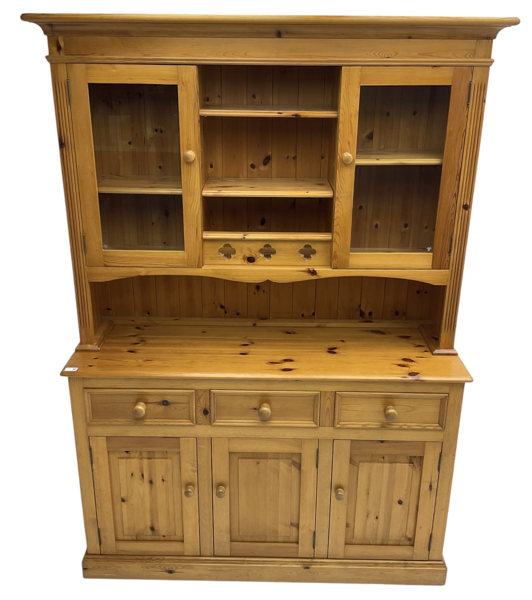 Traditional pine dresser, the rack fitted with two shelves flanked by glazed cupboards, the base with three drawers over three panelled cupboards
