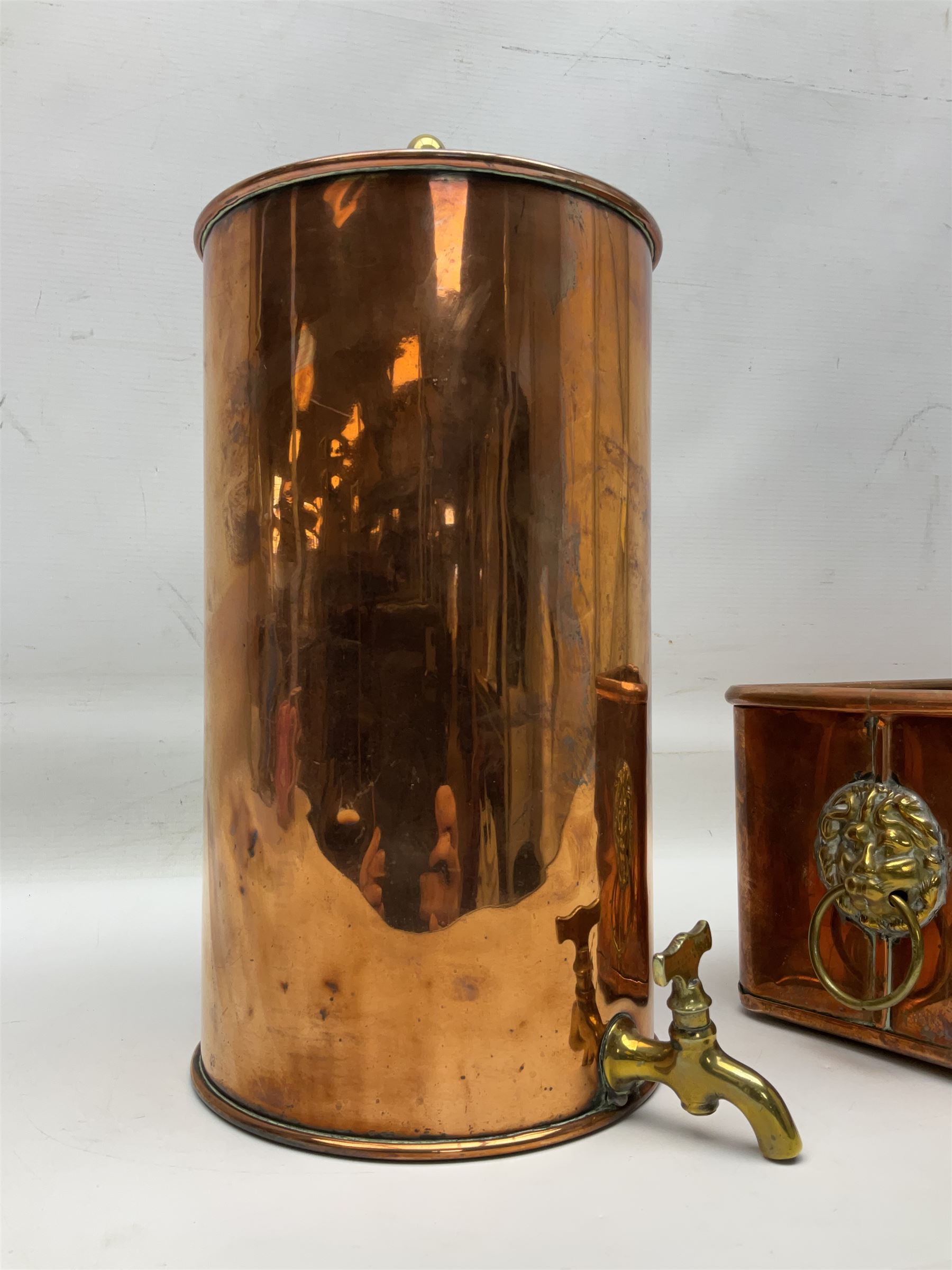 Victorian copper hot water urn, the body of plain cylindrical form with brass tap, the slightly domed lid with brass finial, together with a rectangular copper planter, with twin brass lion mask handles, urn H35cm