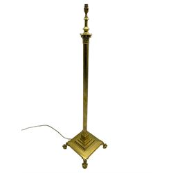 Late 20th century brass telescopic standard lamp in the form of a Corinthian column, Corinthian acanthus leaf capital over reeded shaft, stepped and moulded square base with four extending ball and claw feet
