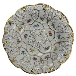 20th century Meissen leaf moulded dish, of circular form with lobed edge, decorated with gilt heightened moulded leaves and painted floral sprigs, with underglaze blue crossed swords mark to base, D27cm
