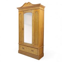 Victorian satin walnut single door wardrobe, shaped cavetto cornice above a central arched mirrored door flanked by recessed panelled sides, the interior fitted with hanging space and later added corner shelves, over a single long drawer with brass handles, on a plinth base