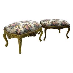 Pair of Louis XV-design giltwood stools, each upholstered in floral tapestry fabric, the carved frame adorned with scrolling foliage and shell motifs, raised on cabriole supports