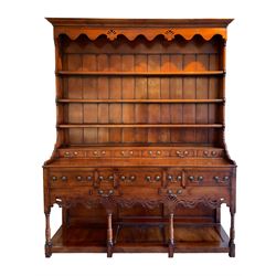 George III design cherry wood dresser, the projecting cornice over shaped frieze with pierced shell decoration, fitted with three shelves over six spice drawers, the base fitted with three long and two short drawers with cock-beaded facias, shaped and pierced apron over turned supports and panelled pot board base 