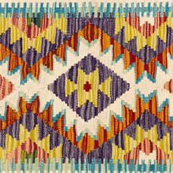 Two Chobi flatweave kilim runners with a repeating stepped diamond medallion design in live green, rust, teal, purple, and ivory, framed by chevron and geometric borders, (2)