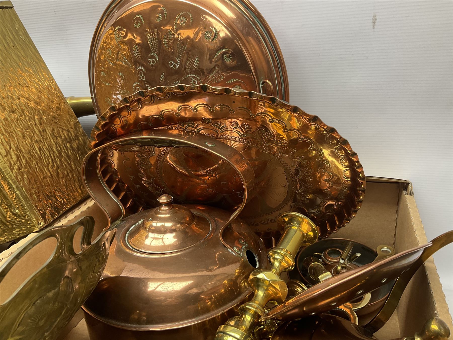 Quantity of copper pans and teapots, dish and sieve with pierced heart decoration and brass handle, together with quantity of brassware to include brass Art Nouveau crumb tray and brush, repousse chargers, fire tool accessories, decorative canon, sword and guns etc