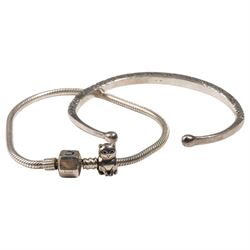 Silver torque bangle and a silver Chamilla charm bracelet 
