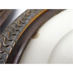 Pair mid 19th century Sevres porcelain plates, with gilt Louis Phillippe crowned monogram to centre upon a white glazed ground, with blue crowned LP mark, iron red destination mark for Chateau D'Eu, and chrome green cancelled potting mark S67 beneath, in carved oak mounts, overall D34cm
     