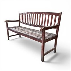 Teak garden bench, with slatted seat and spindle back, shaped armrests, finished in weathered red painted finish.