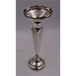Early 20th century silver vase, of trumpet form, the fluted rim embossed with C scrolls and roses, with faceted stem, upon a circular stepped weighted foot, hallmarked Chester 1911, maker's mark worn and indistinct, H25.7cm