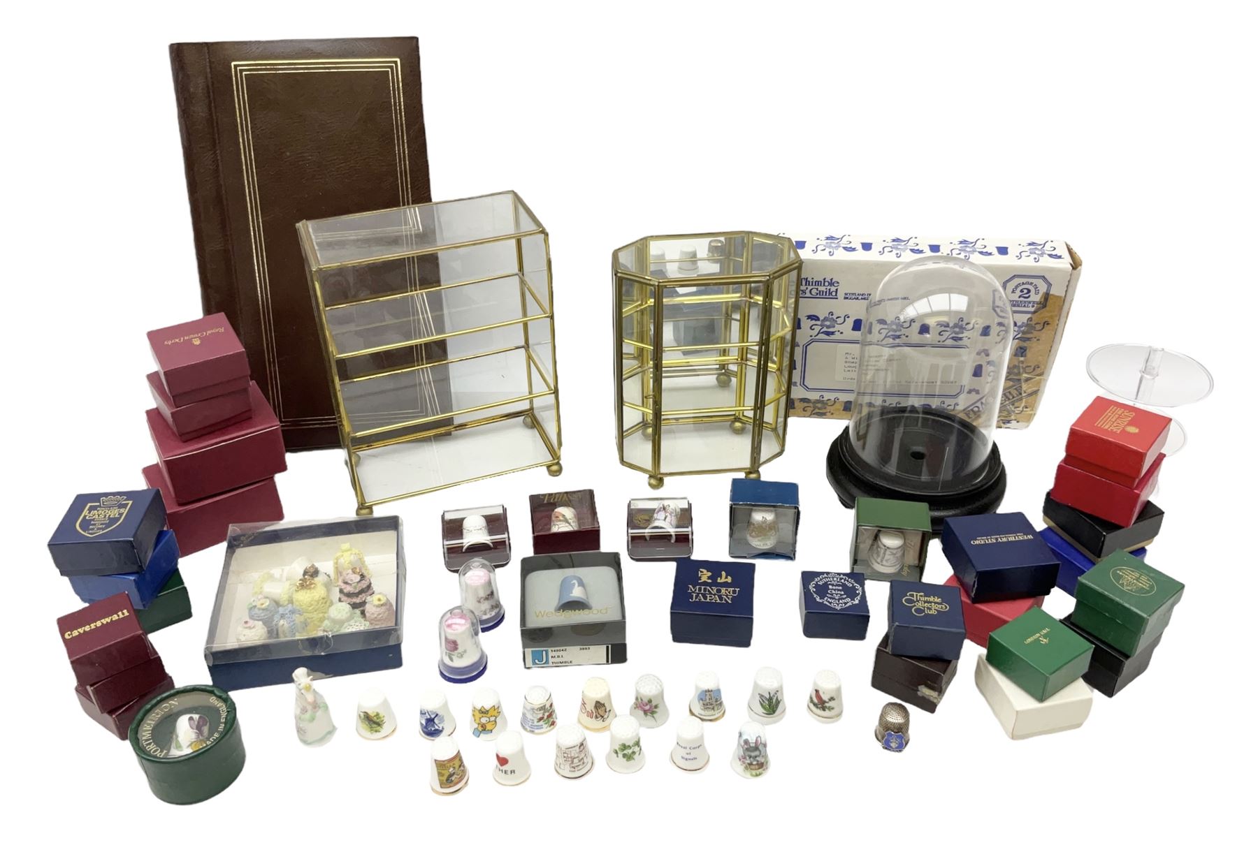 Quantity of thimbles to include twelve Irish Dresden lace examples, Royal Crown Derby, Spode, Portmeirion, Wedgwood, Royal Grafton etc, together with three display cases, many with certificates
